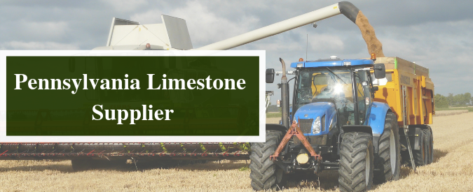a sign for Pennsylvania limestone supplier with a tractor in the background